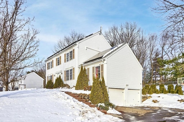 view of front of house featuring fence and an attached garage