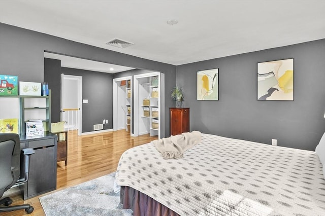 79 Flanagan Dr, Framingham, MA 01701 - bedroom with wood finished floors, baseboards, a spacious closet, an office area, and a closet