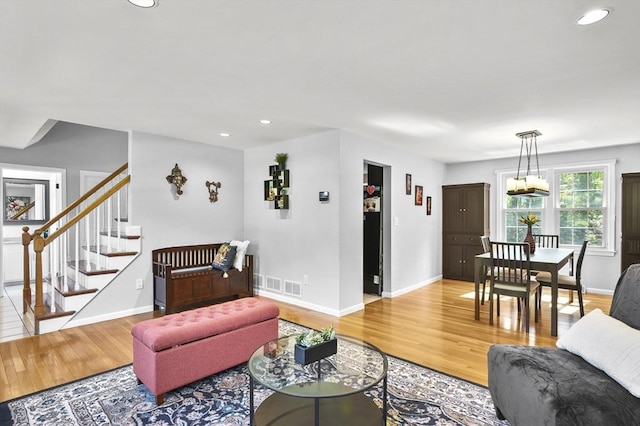 79 Flanagan Dr, Framingham, MA 01701 - living area with light wood finished floors, baseboards, recessed lighting, and stairs