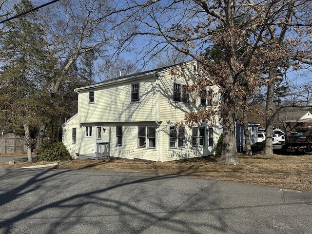 colonial home featuring aphalt driveway