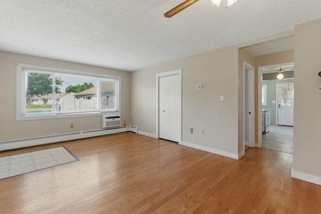 1064 James St Unit 1064, Chicopee, MA 01022 - unfurnished room with ceiling fan, light wood-style flooring, a textured ceiling, baseboard heating, and baseboards