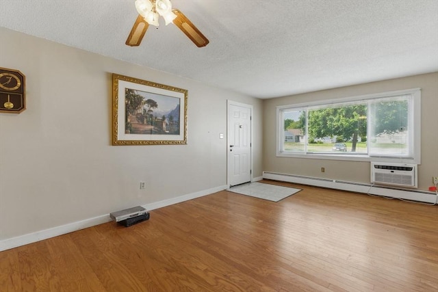 1064 James St Unit 1064, Chicopee, MA 01022 - entrance foyer featuring a textured ceiling, wood finished floors, baseboard heating, a ceiling fan, and a wall mounted AC