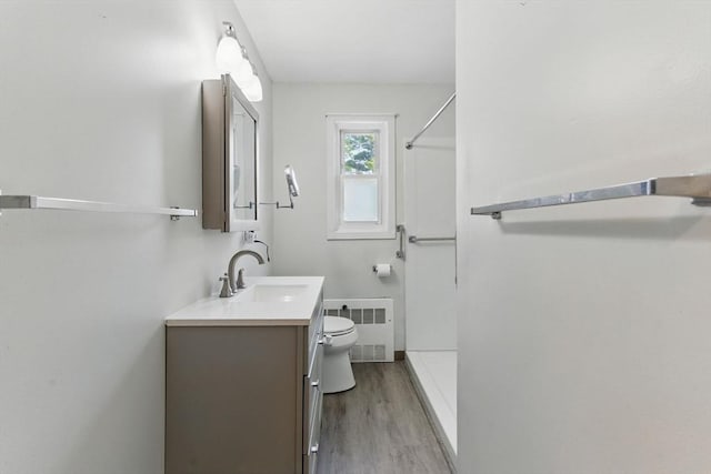 1064 James St Unit 1064, Chicopee, MA 01022 - bathroom featuring radiator heating unit, toilet, vanity, a shower, and wood finished floors