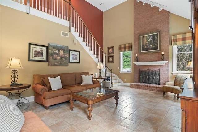 54 Wagon Rd, Walpole, MA 02081 - living room featuring high vaulted ceiling, stairway, track lighting, and a brick fireplace