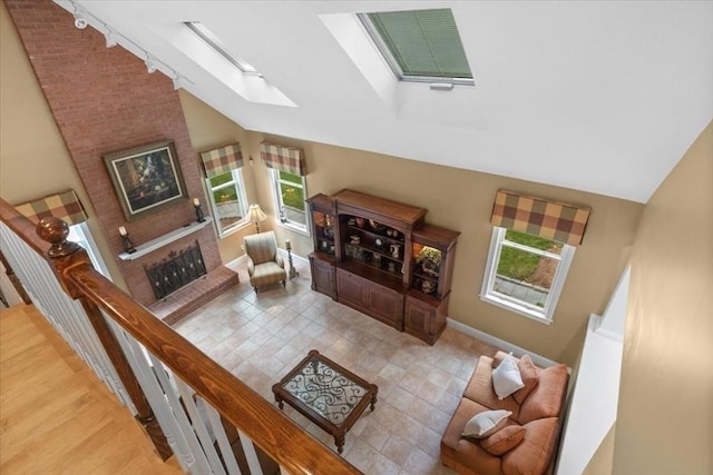 54 Wagon Rd, Walpole, MA 02081 - living room featuring a skylight, lofted ceiling, a fireplace, and track lighting