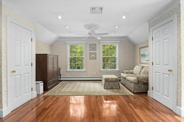 54 Wagon Rd, Walpole, MA 02081 - living area featuring baseboard heating, wallpapered walls, wood finished floors, vaulted ceiling, and ceiling fan