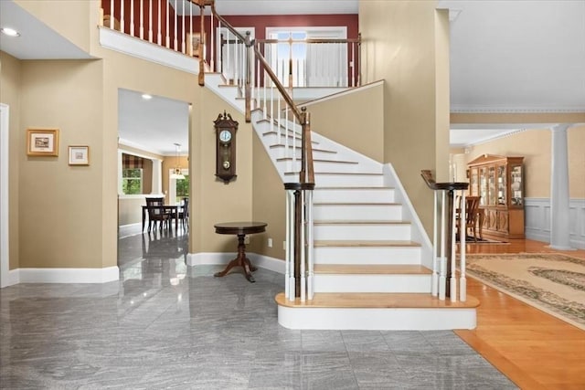 54 Wagon Rd, Walpole, MA 02081 - staircase with ornate columns, ornamental molding, a towering ceiling, and recessed lighting