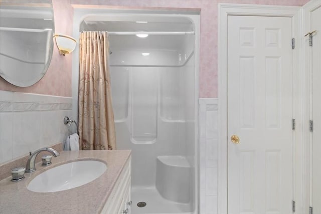 54 Wagon Rd, Walpole, MA 02081 - bathroom featuring a shower with shower curtain, a wainscoted wall, vanity, and tile walls