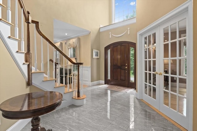 54 Wagon Rd, Walpole, MA 02081 - foyer entrance featuring a high ceiling, french doors, stairs, and arched walkways