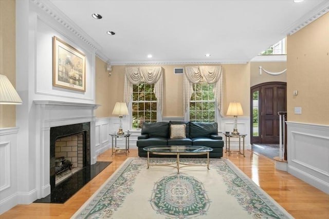 54 Wagon Rd, Walpole, MA 02081 - living area with a decorative wall, plenty of natural light, wood finished floors, a fireplace with flush hearth, and wainscoting