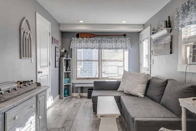 living room with plenty of natural light and light hardwood / wood-style floors