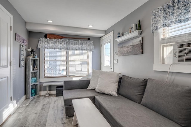 living room featuring cooling unit and light hardwood / wood-style floors