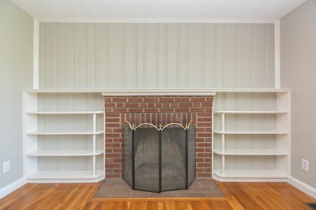 80 Dobbins St, Waltham, MA 02451 - detailed view of wood finished floors, baseboards, and a fireplace