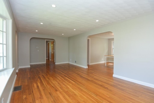 80 Dobbins St, Waltham, MA 02451 - spare room featuring arched walkways, light wood-type flooring, recessed lighting, and baseboards