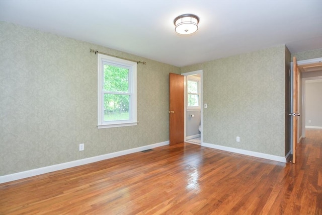 80 Dobbins St, Waltham, MA 02451 - unfurnished room featuring wood finished floors, wallpapered walls, and baseboards