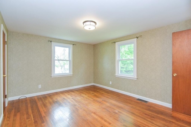 80 Dobbins St, Waltham, MA 02451 - spare room featuring plenty of natural light, wood finished floors, and baseboards