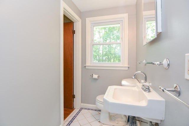 80 Dobbins St, Waltham, MA 02451 - bathroom with baseboards, a sink, tile patterned flooring, and toilet