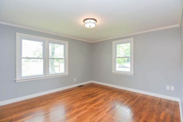 80 Dobbins St, Waltham, MA 02451 - unfurnished room with plenty of natural light, baseboards, wood finished floors, and crown molding