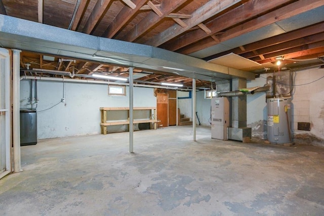 80 Dobbins St, Waltham, MA 02451 - basement with water heater, stairway, and washer / clothes dryer