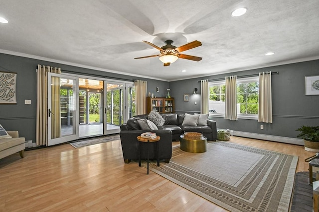 11 Fern Ave, Amesbury, MA 01913 - living area with a baseboard radiator, a ceiling fan, light wood finished floors, crown molding, and recessed lighting
