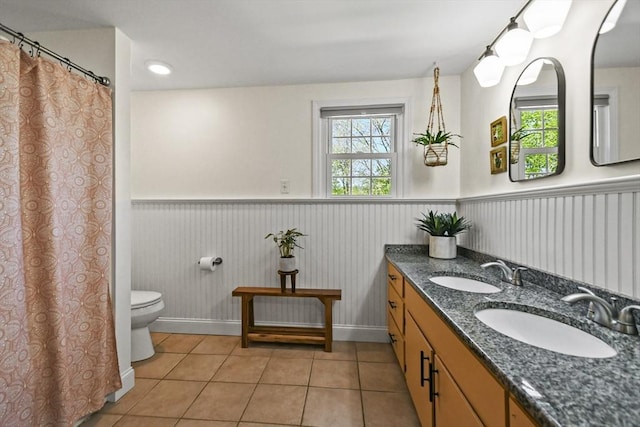 11 Fern Ave, Amesbury, MA 01913 - bathroom featuring tile patterned floors, a wainscoted wall, toilet, double vanity, and baseboards