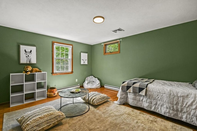11 Fern Ave, Amesbury, MA 01913 - bedroom featuring wood finished floors, a baseboard radiator, and baseboards