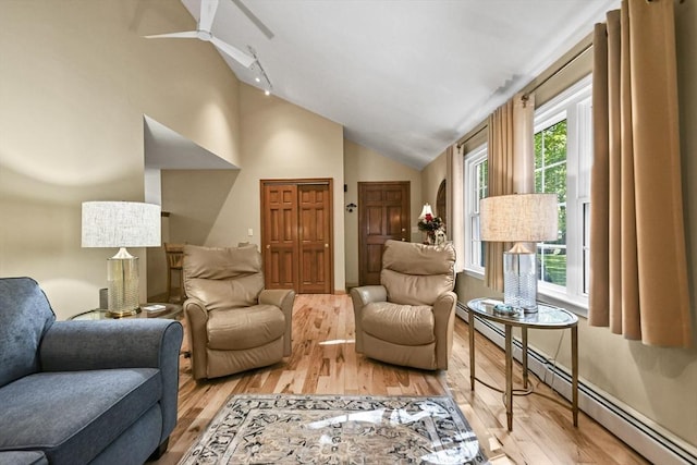 11 Fern Ave, Amesbury, MA 01913 - living room with a baseboard heating unit, light wood-type flooring, a ceiling fan, and high vaulted ceiling