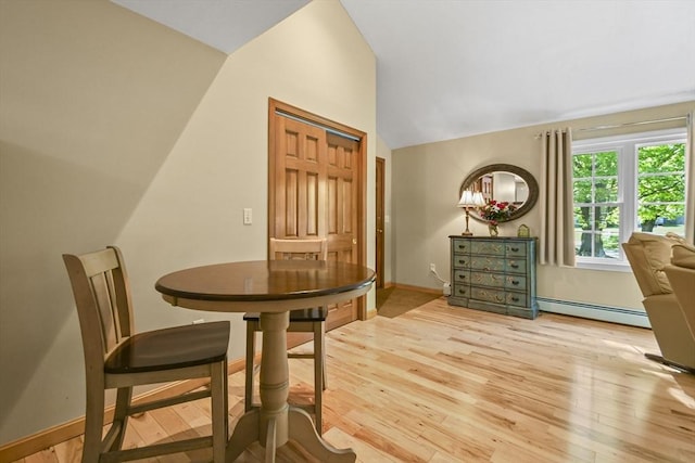 11 Fern Ave, Amesbury, MA 01913 - dining area with a baseboard heating unit, vaulted ceiling, light wood-type flooring, and baseboards