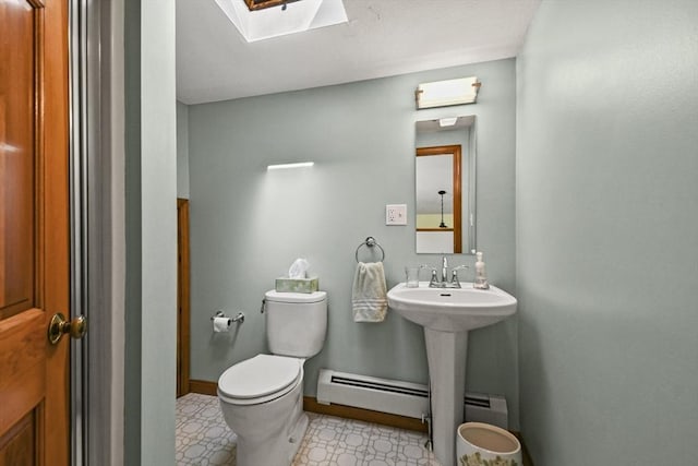 11 Fern Ave, Amesbury, MA 01913 - half bathroom featuring toilet, a baseboard radiator, a skylight, and baseboards