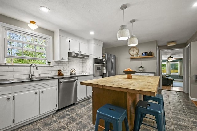 11 Fern Ave, Amesbury, MA 01913 - kitchen with stainless steel appliances, a sink, decorative backsplash, wooden counters, and white cabinets