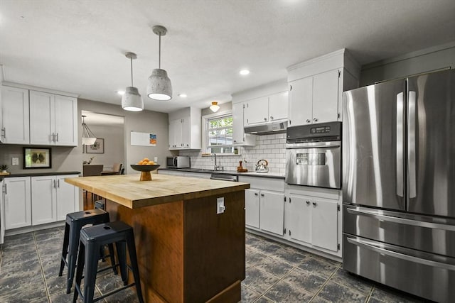 11 Fern Ave, Amesbury, MA 01913 - kitchen featuring stainless steel appliances, wooden counters, white cabinetry, backsplash, and a center island