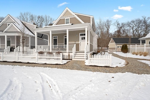 view of front facade featuring a porch and fence