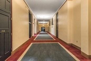 hall featuring baseboards