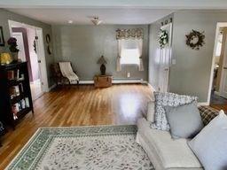 sitting room with hardwood / wood-style flooring and a baseboard radiator