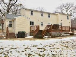 snow covered property with a wooden deck