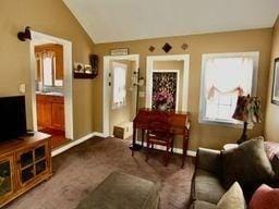 carpeted living room featuring lofted ceiling