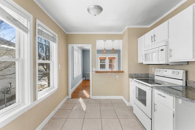 kitchen with radiator heating unit, white appliances, white cabinets, crown molding, and light tile patterned floors