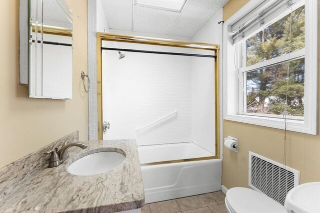 full bath featuring tile patterned flooring, visible vents, toilet, enclosed tub / shower combo, and vanity
