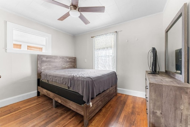 bedroom featuring hardwood / wood-style flooring, a ceiling fan, baseboards, and ornamental molding