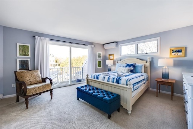 bedroom featuring access to outside, light carpet, an AC wall unit, and baseboards
