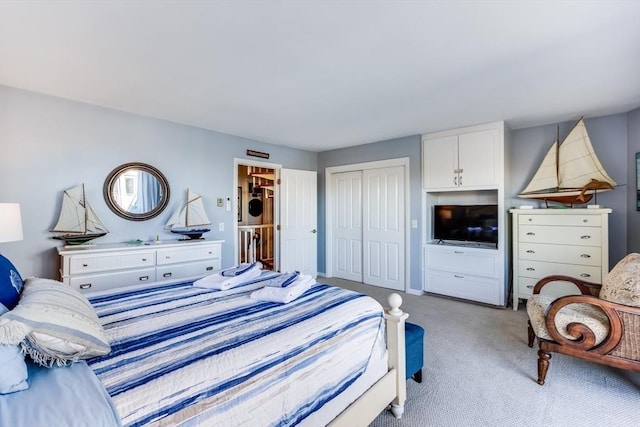 carpeted bedroom featuring a closet and baseboards