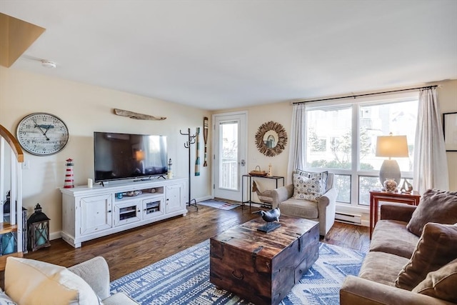 living room with baseboards, a baseboard heating unit, and wood finished floors
