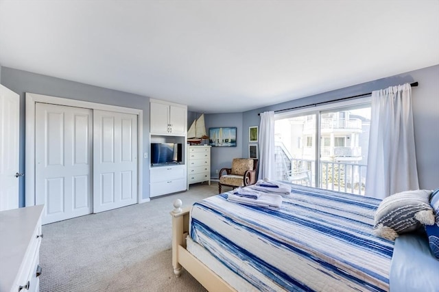 bedroom featuring a closet and light colored carpet