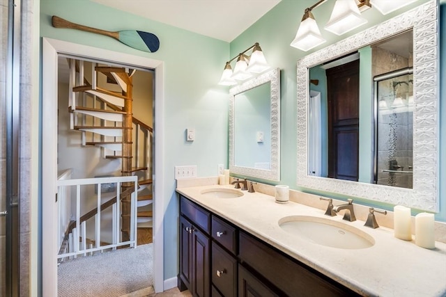 bathroom with an enclosed shower, double vanity, and a sink