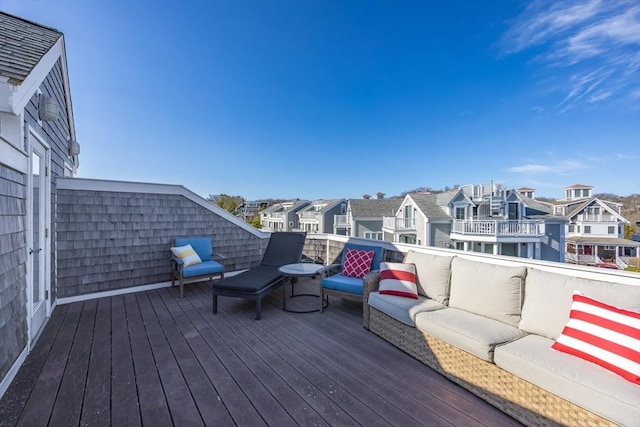 wooden deck with an outdoor living space and a residential view
