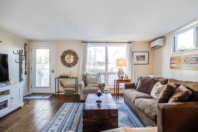 living area with an AC wall unit and dark wood-style floors