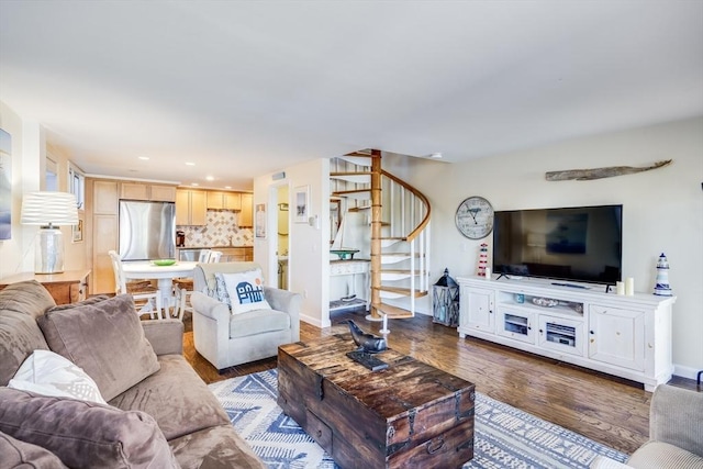 living room with recessed lighting, stairs, baseboards, and wood finished floors