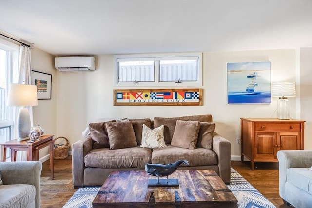 living room featuring baseboards, plenty of natural light, wood finished floors, and a wall mounted air conditioner