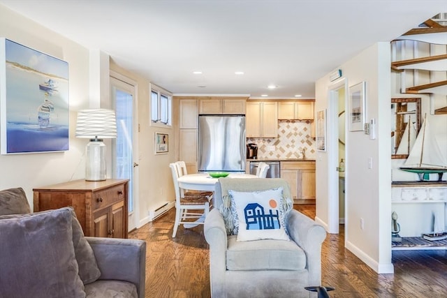 dining space with recessed lighting, a baseboard radiator, baseboards, and wood finished floors