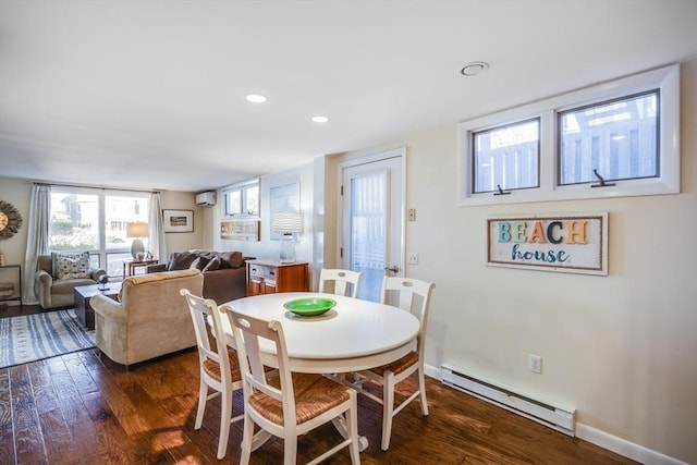 dining room featuring a wall mounted air conditioner, baseboard heating, baseboards, and dark wood-style floors